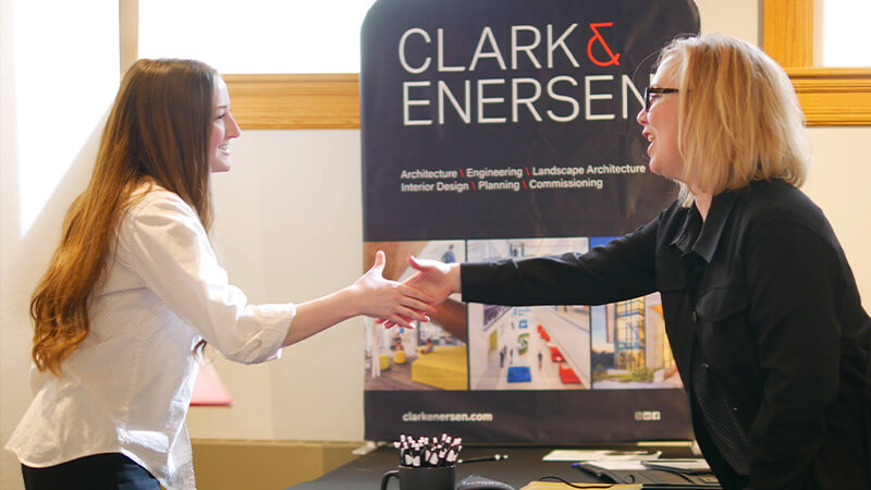 Student shaking hands with representative at career fair