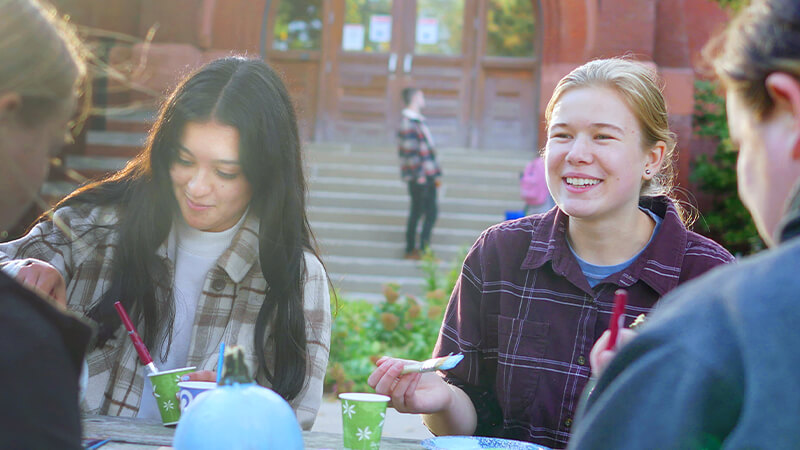 Students sitting outside and eating a meal