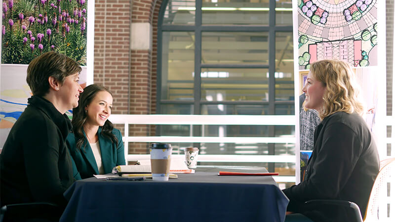 Students sitting at table talking