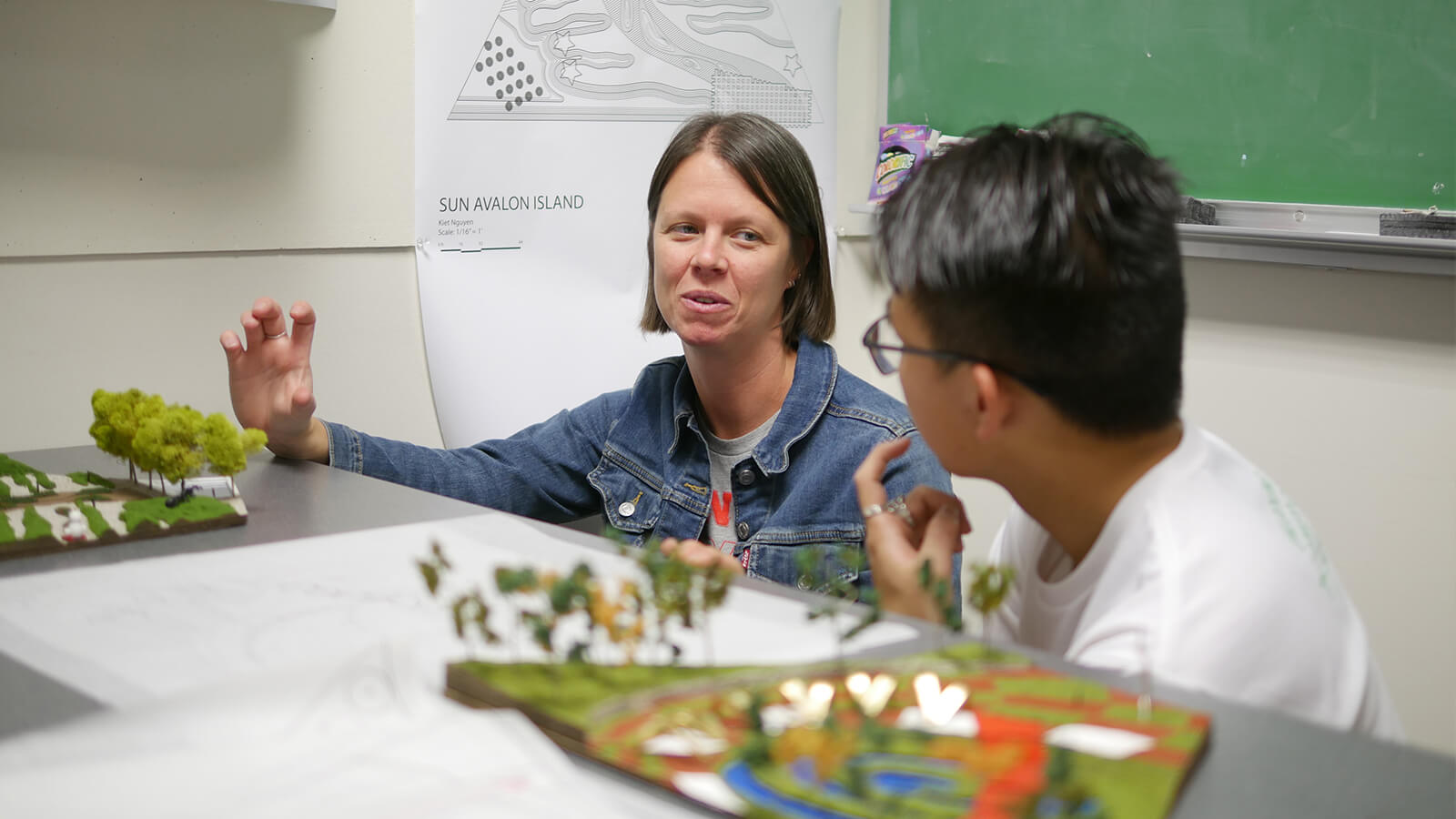 Student discussing work with faculty member