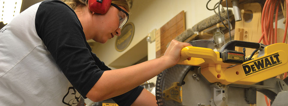 a student using a power saw