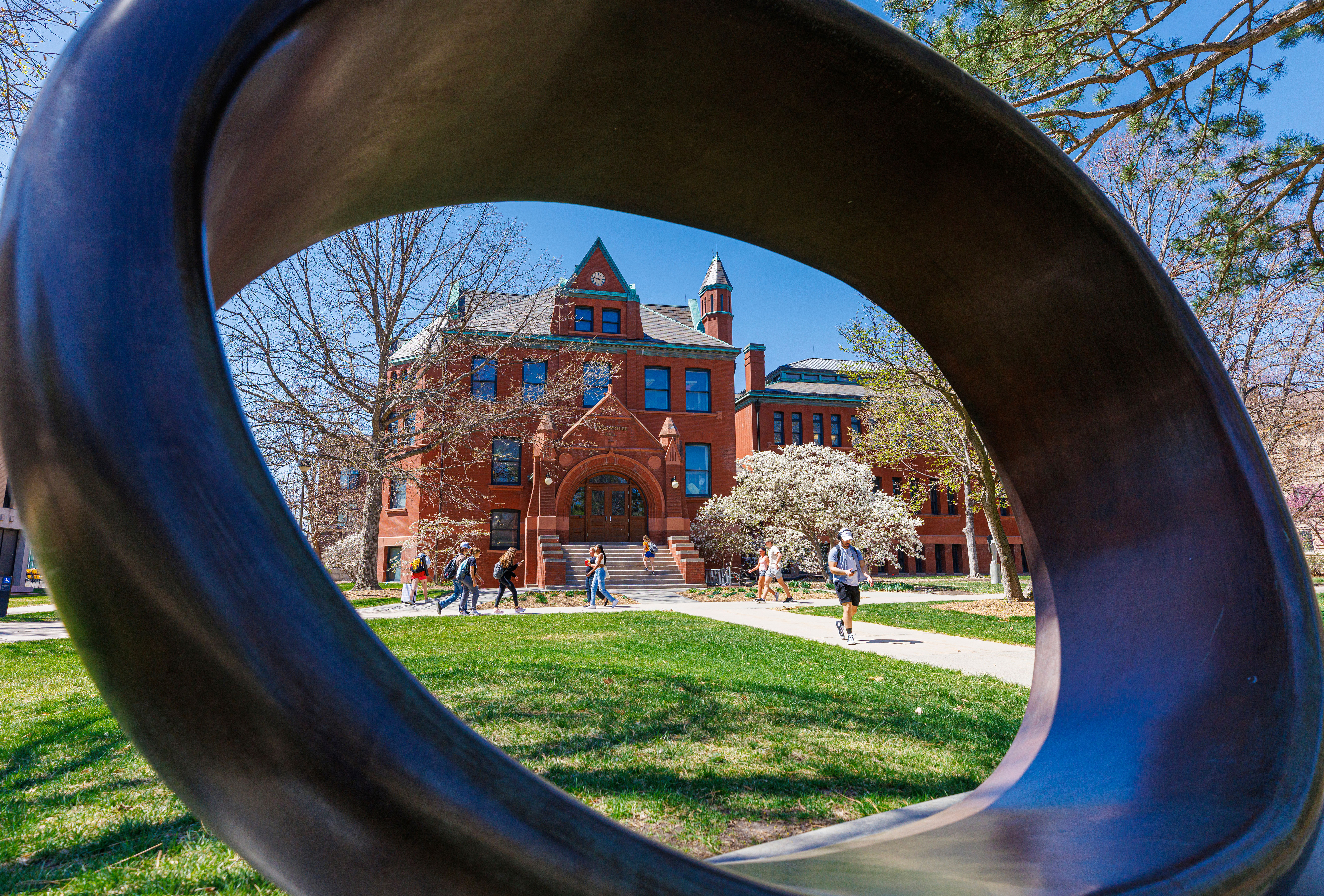 the college of architecture through a circular sculpture in front of it