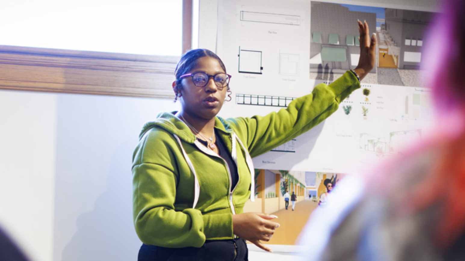 Student presenting project in front of classroom