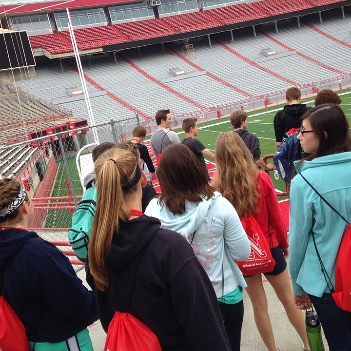 high school students looking at the field from the stands of memorial stadium