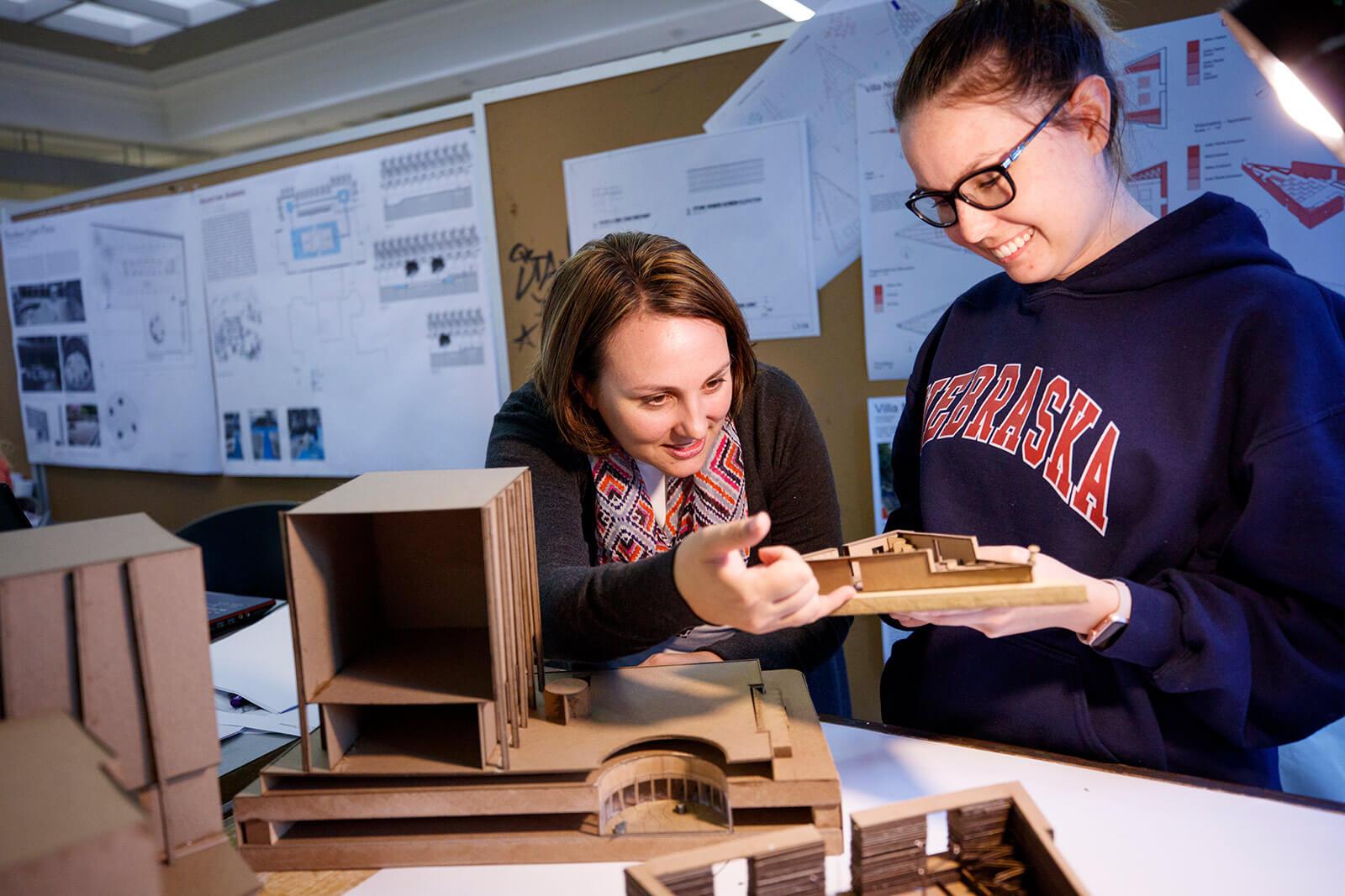 Two students examining project together