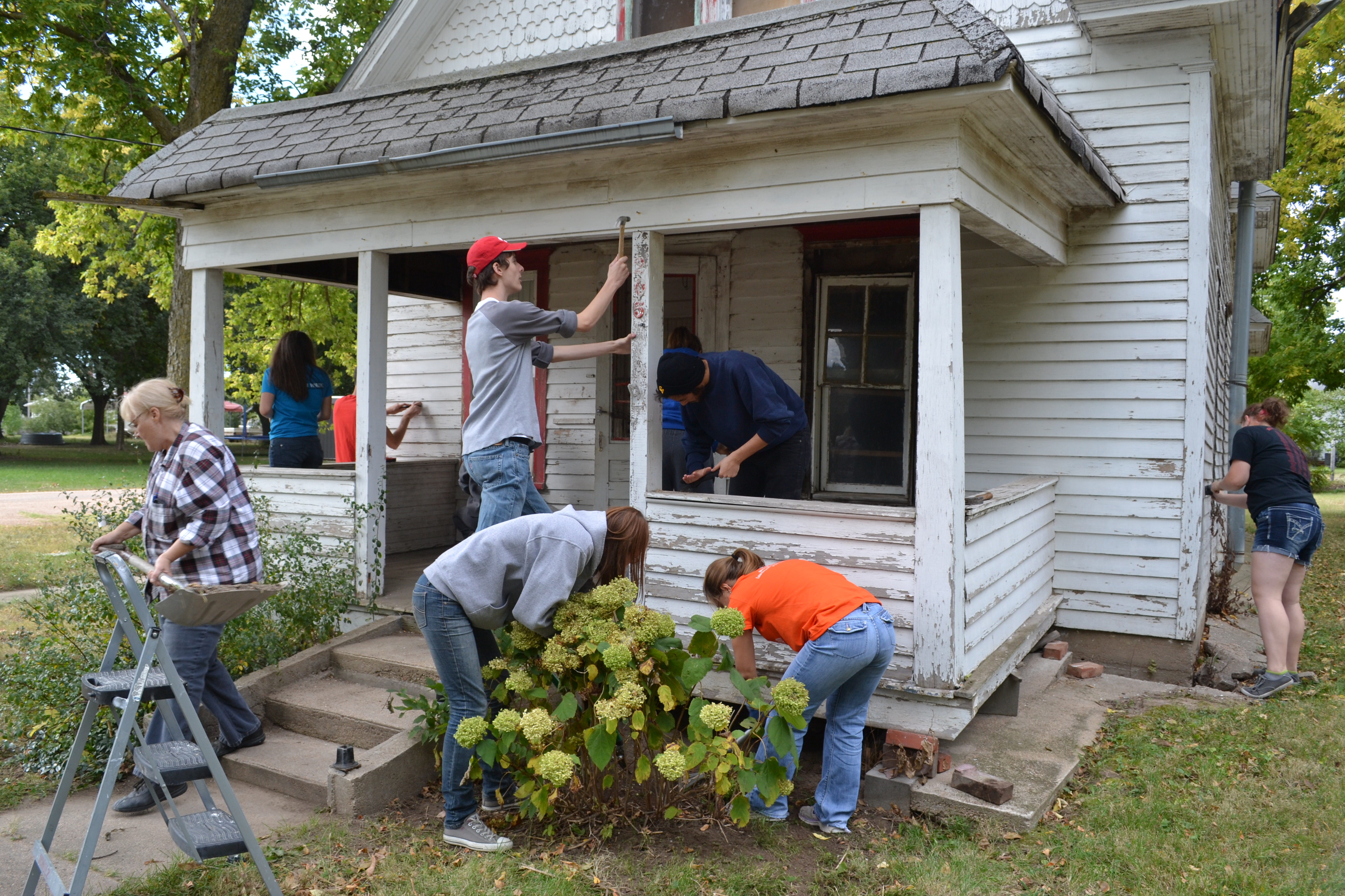 a group of students working together to build a house