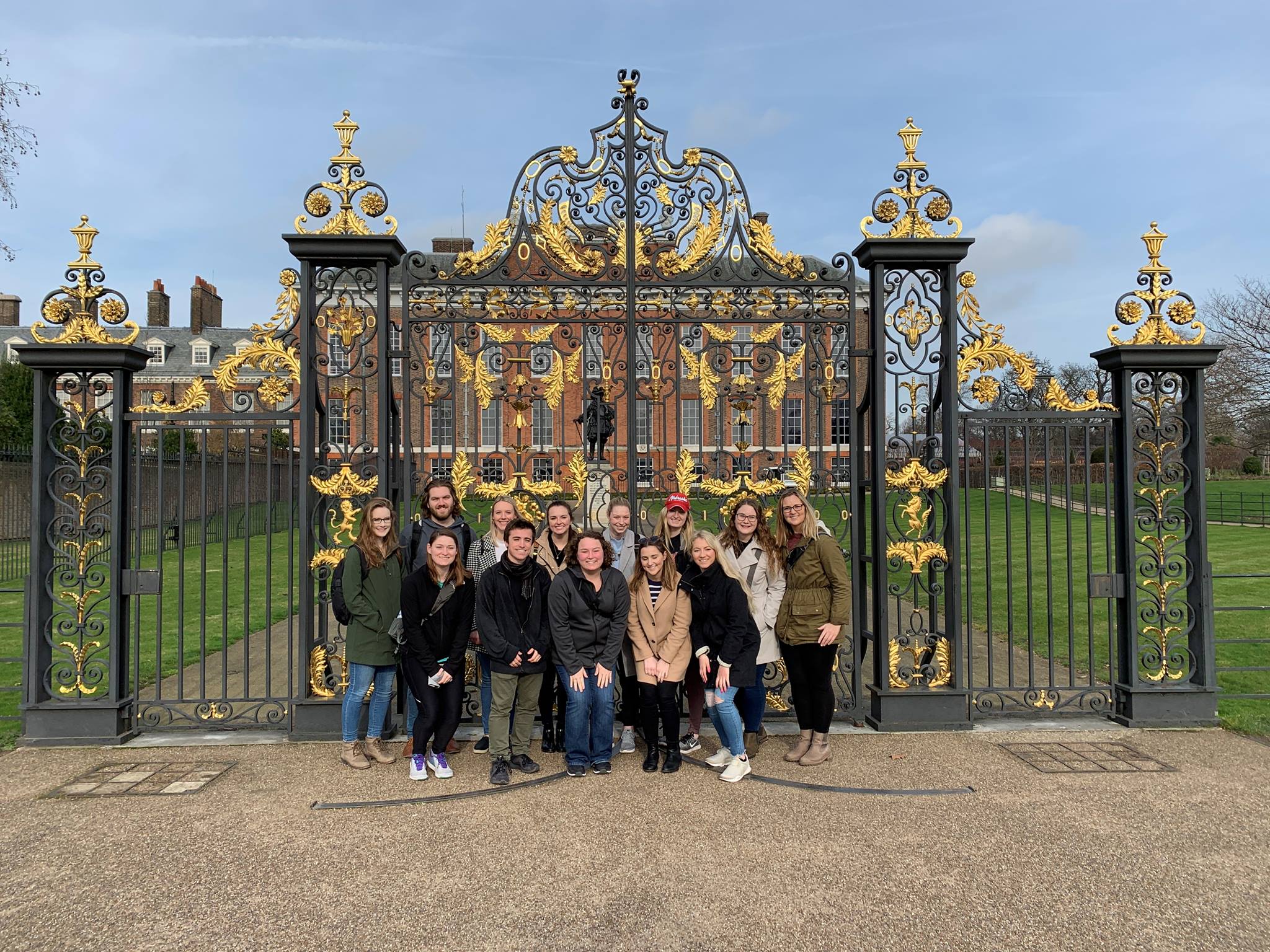 a group of students standing in front of Kensington palace