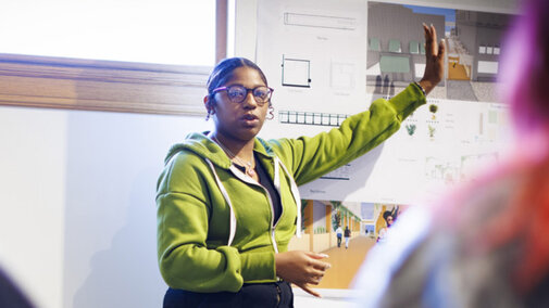 Student presenting project in front of classroom