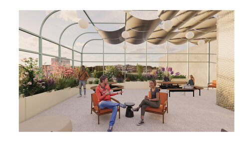 Bright open space with glass walls, indoor plants, seating, and people chatting and relaxing.