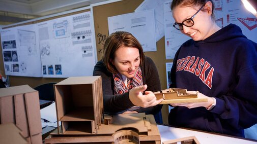 Two students examining project together