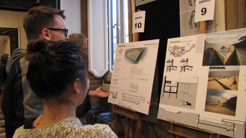 teacher reviewing a students architecture work