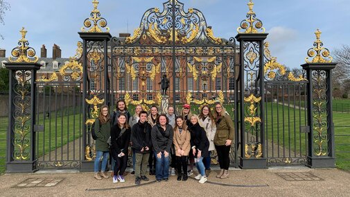 a group of students standing in front of Kensington palace