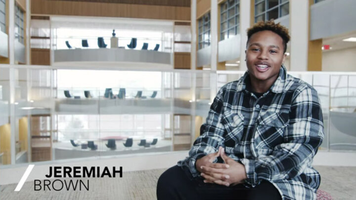 jeremiah brown sitting and smiling at the camera