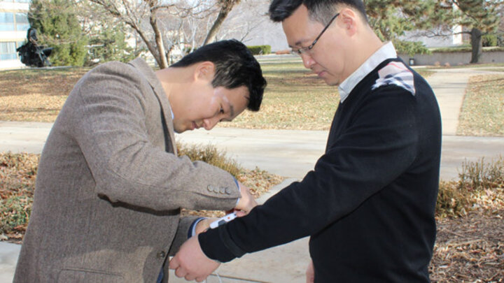 Changbum Ahn attatching a walking device to Yunwoo Nam