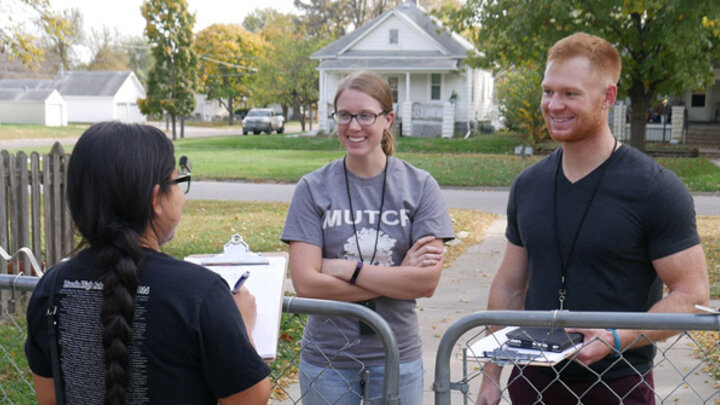 a student and two faculty members out in one of Lincoln's neighborhoods with clipboards