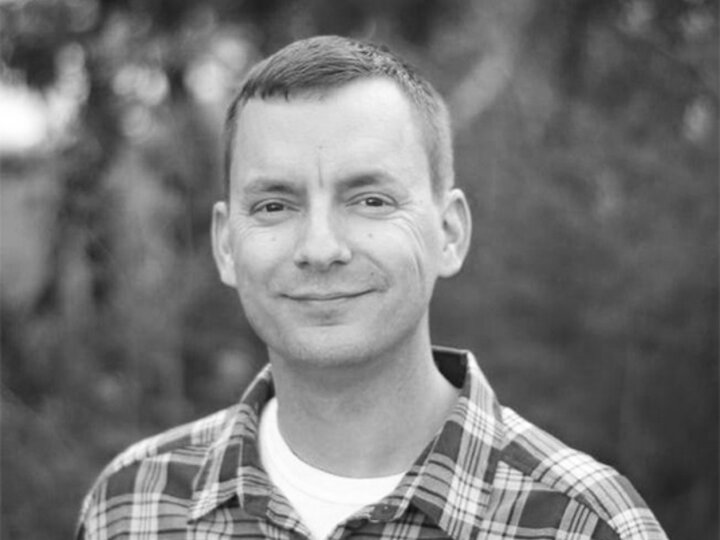 black and grey headshot of a symposium speaker