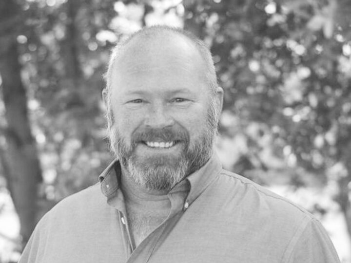 black and grey headshot of a symposium speaker