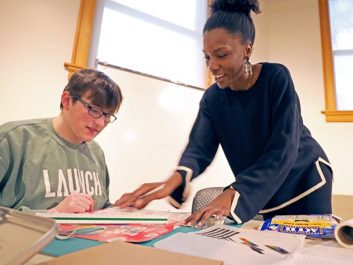 a teacher helping her student