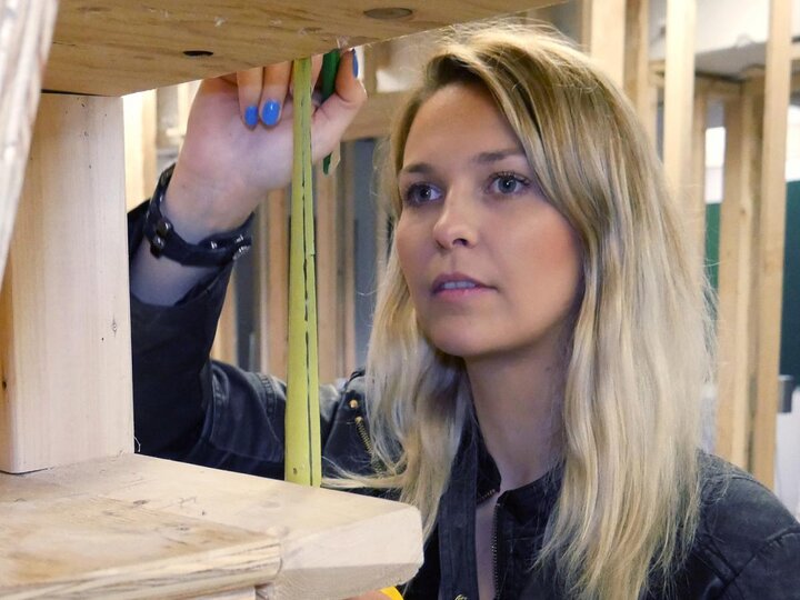 student measuring the space between two pieces of wood