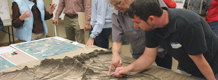 Students and faculty looking at Landscape Architecture project