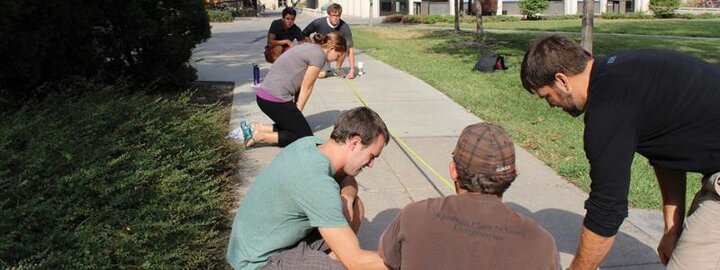 Students measuring section of concrete