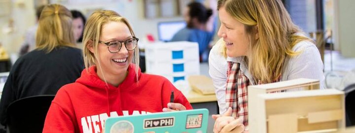 Student laughing with faculty member